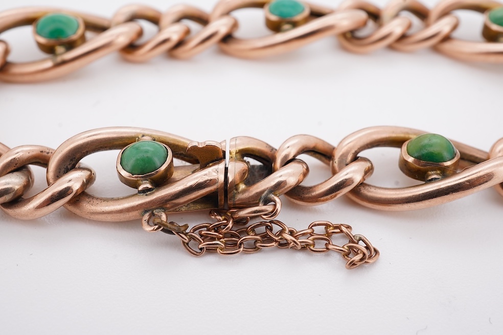 An early 20th century yellow metal (stamped 9c) and seven stone cabochon turquoise set curb link bracelet, 19cm, gross weight 14 grams. Condition - poor to fair